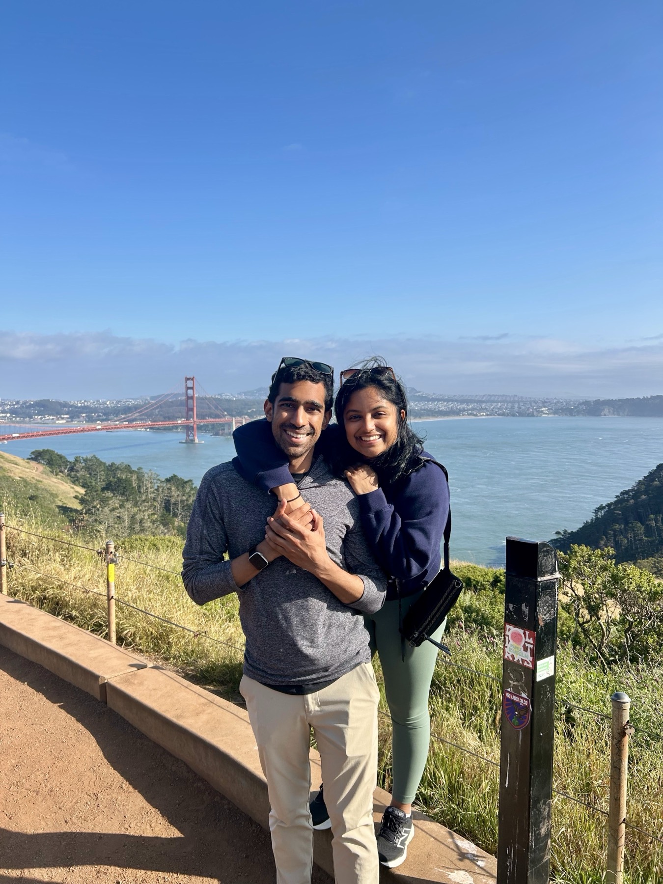 Manu and Nikhil in the Marin Headlands with the Golden Gate Bridge behind them