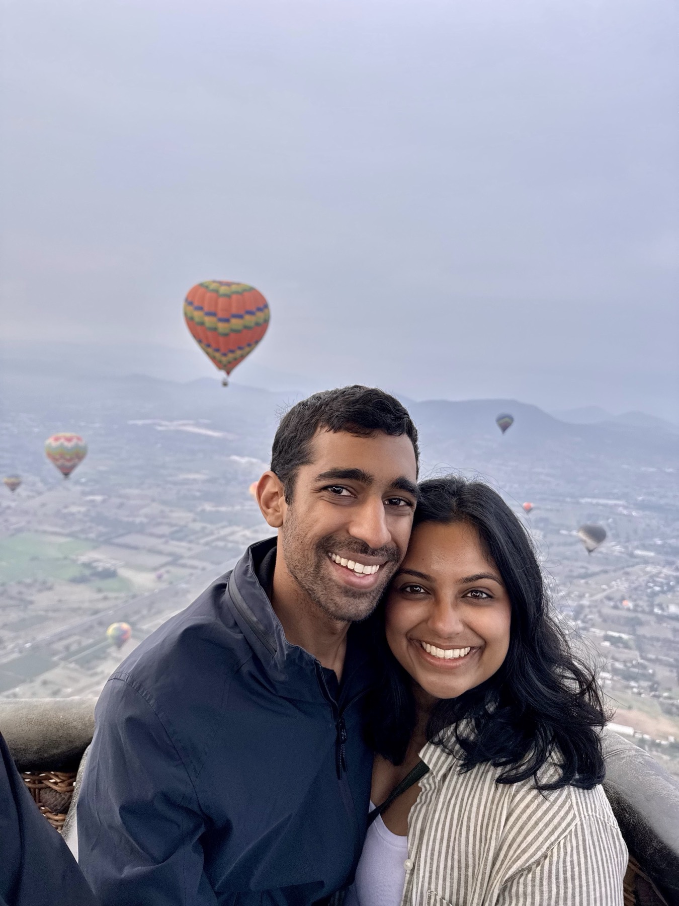 Manu and Nikhil in a hot air balloon over Teotihuacán, Mexico